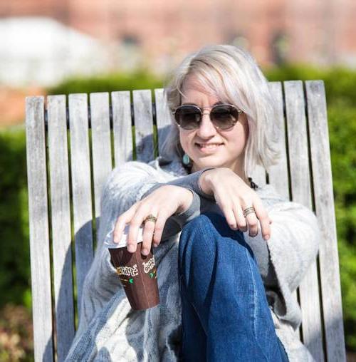 Tiffany Aurora sitting in the sun in an adirondak chair